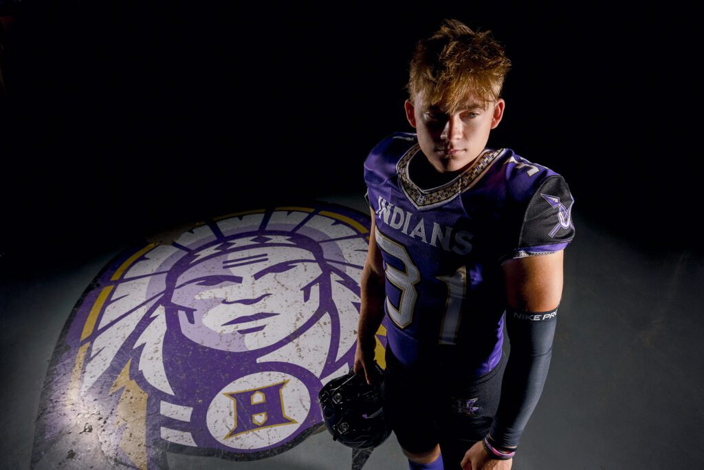 Hallsville senior Landyn Sievers stands by Indian Logo on locker room floor.