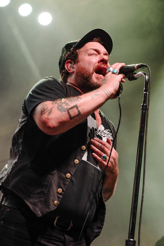 Nathaniel Rateliff singing on stage.
