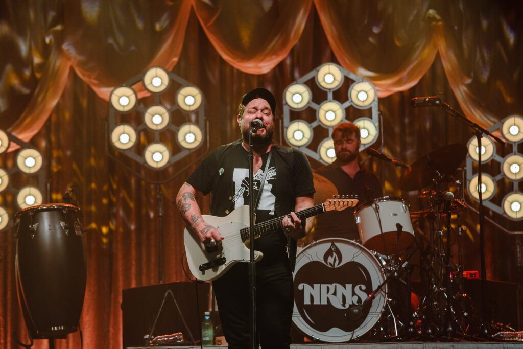 Nathaniel Rateliff singing on stage.