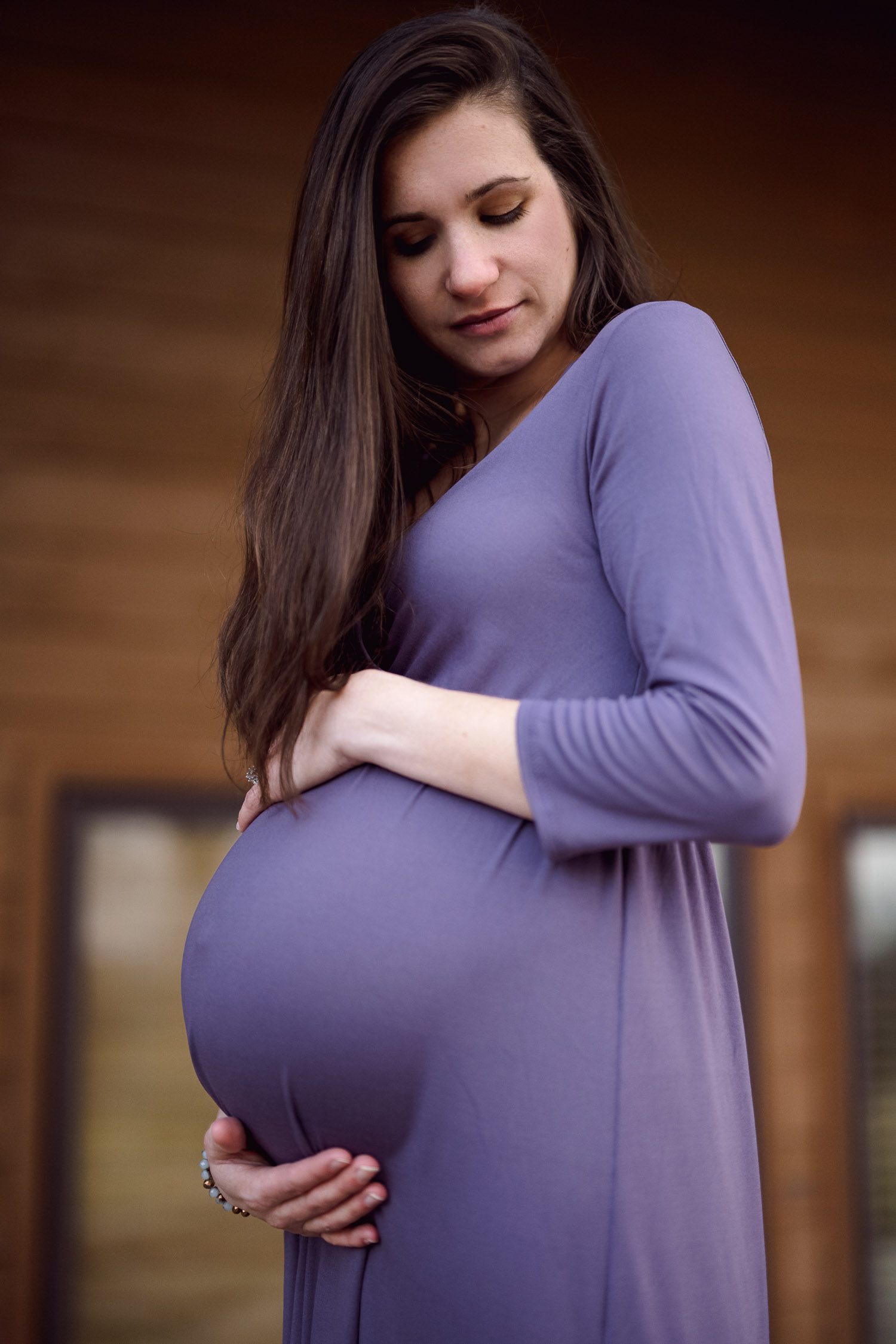 mom to be wearing a purple maternity dress