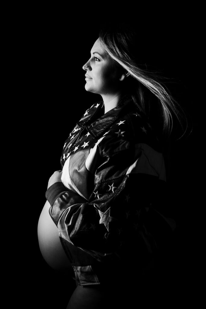 naked pregnant woman wearing American flag jacket