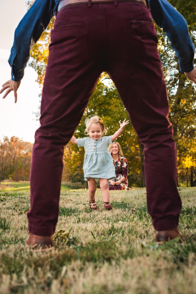 baby girl running to dad