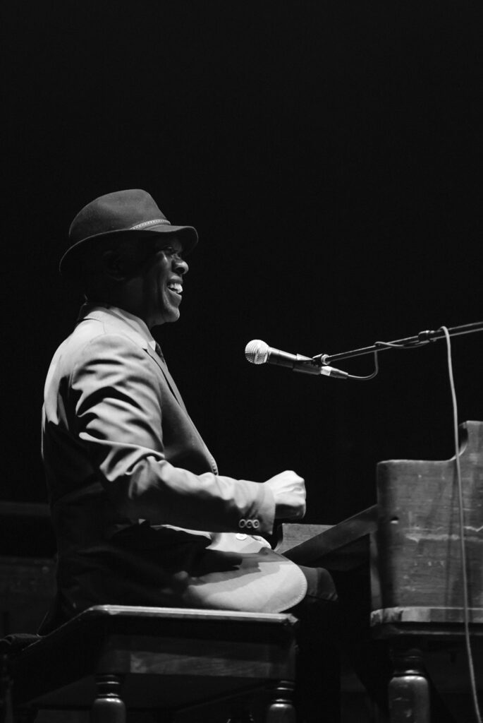 Booker T. Jones laughs while playing organ