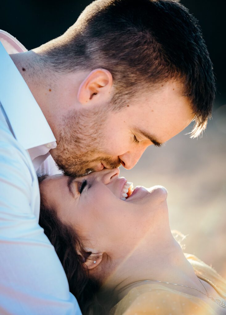 girl laying head on chest of fiance and kissing her nose