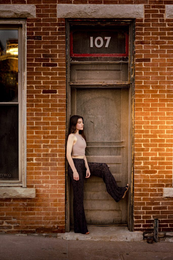 Senior girl wearing bell bottoms and tank