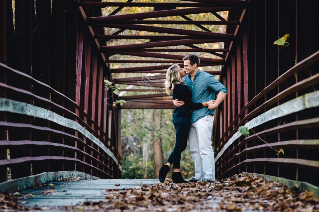 couple on bridge at Katy Trail with leaves