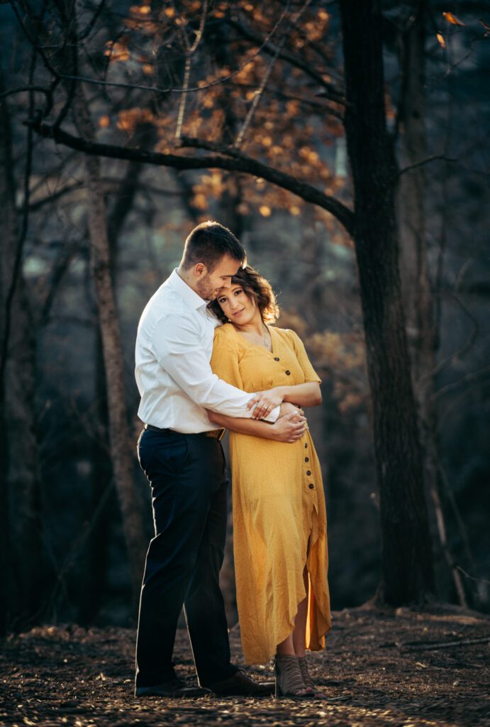 holding girl from behind in woods