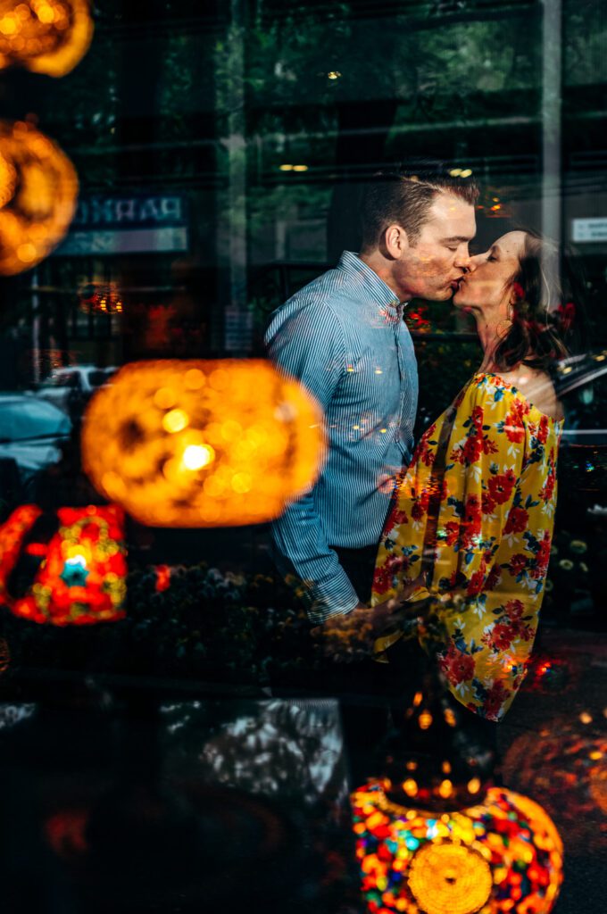 couple kissing through lantern window