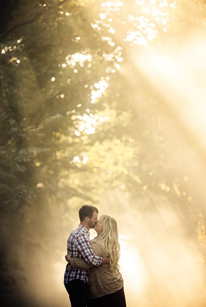 Couple kissing on dusty sun drenched road