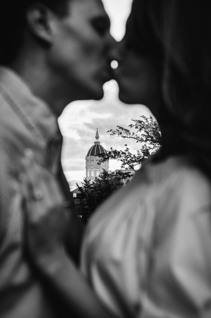 couple kissing at in front of Jesse Hall