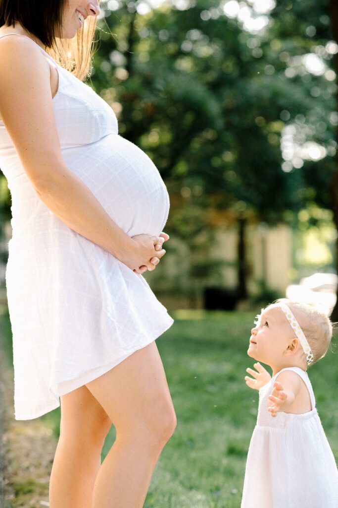 daughter running to pregnant belly