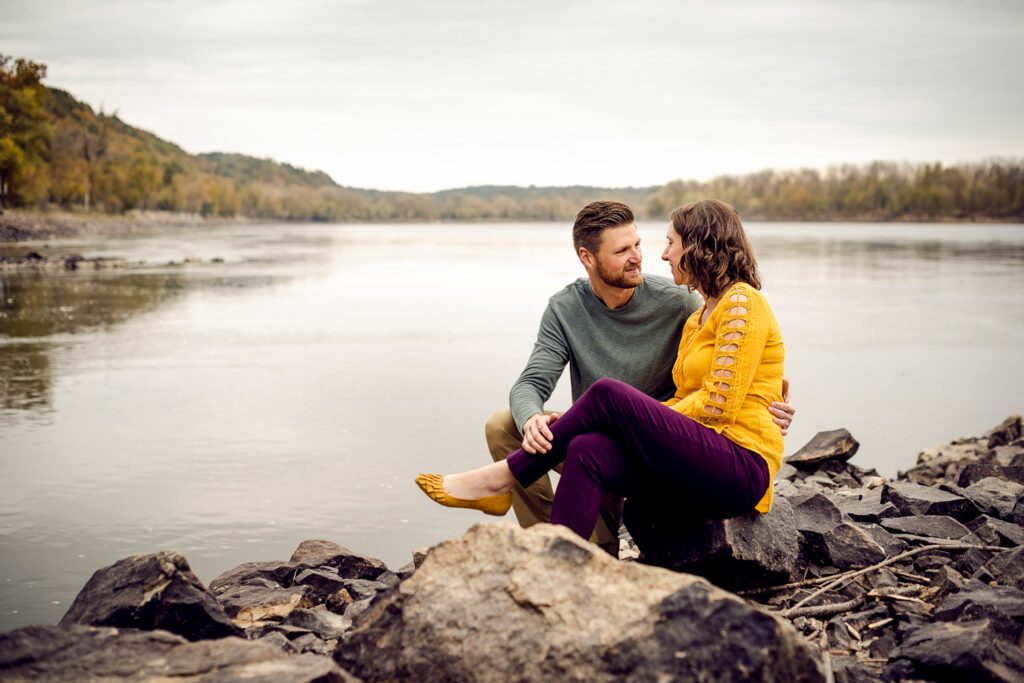 engaged couple sitting in front of Missouri River