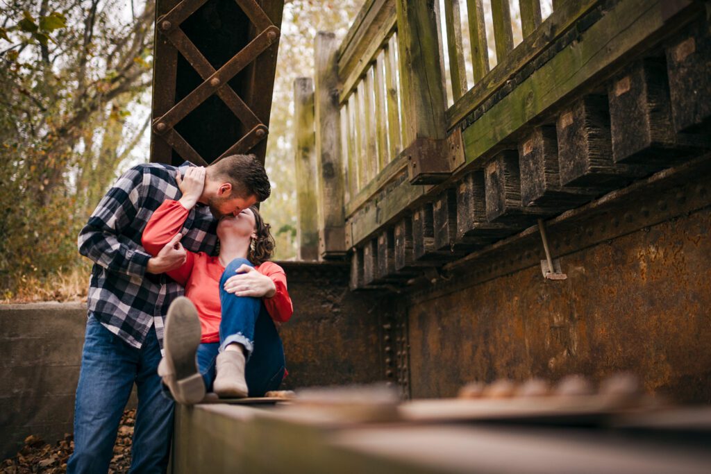 couple kissing under bridge at Missouri River