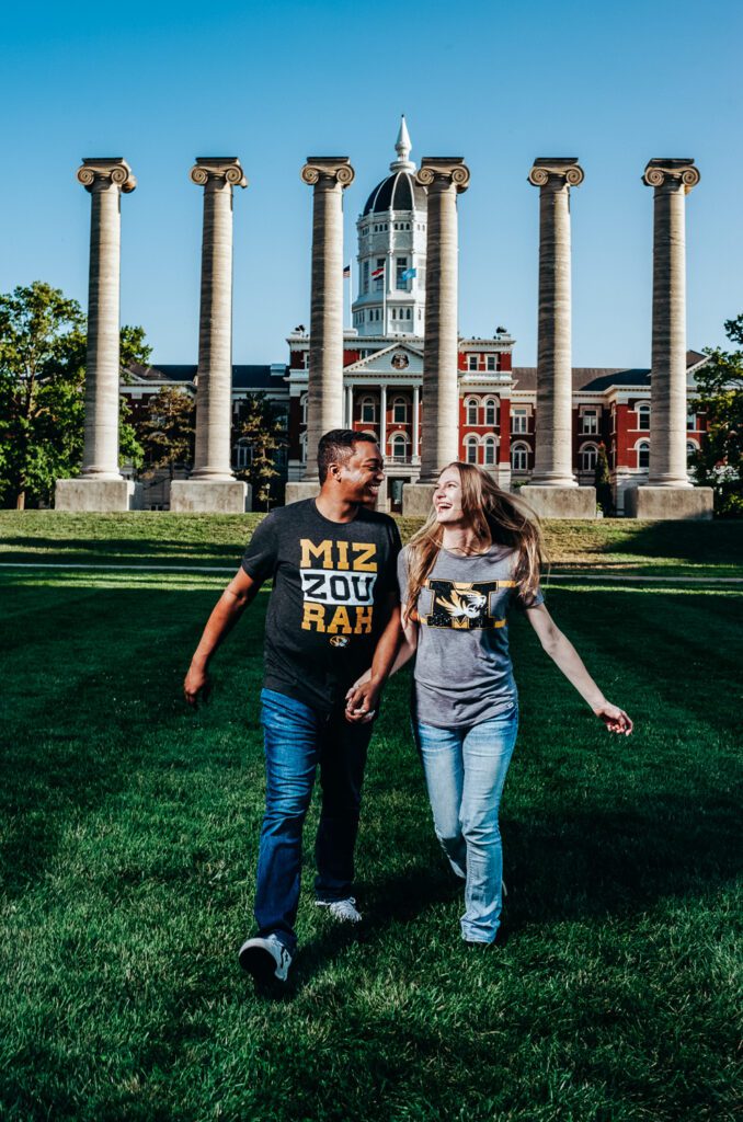 couple running in front of Mizzou columns