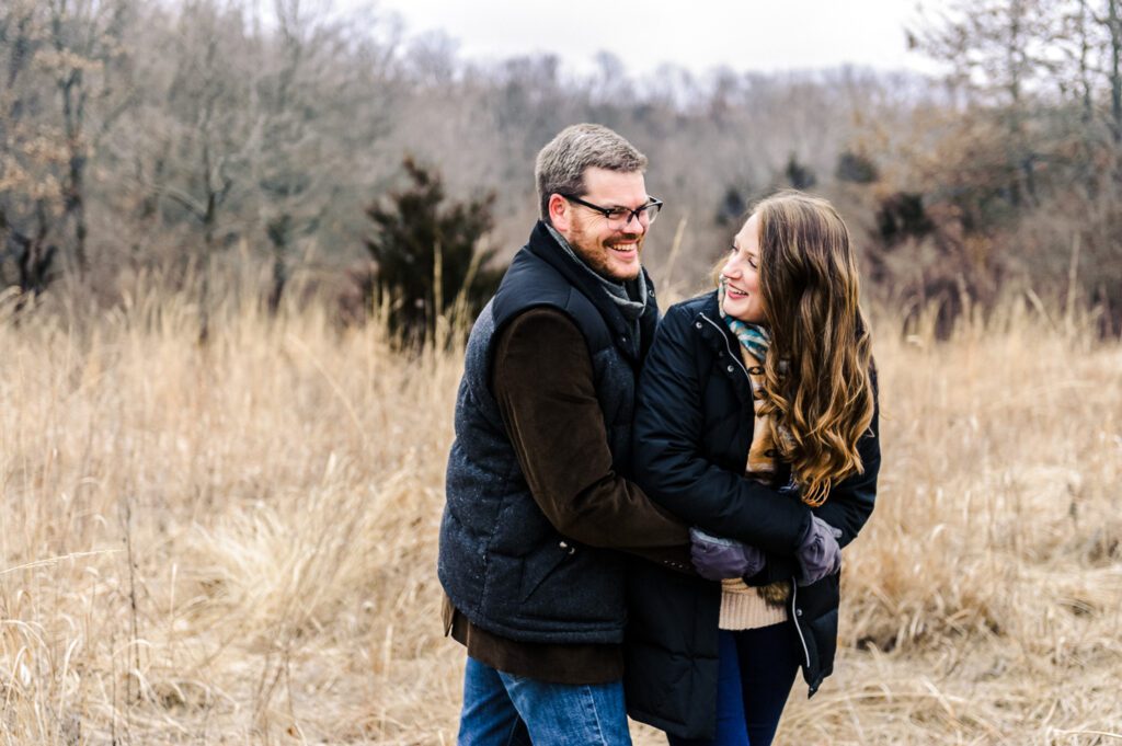 couple embracing in winter field