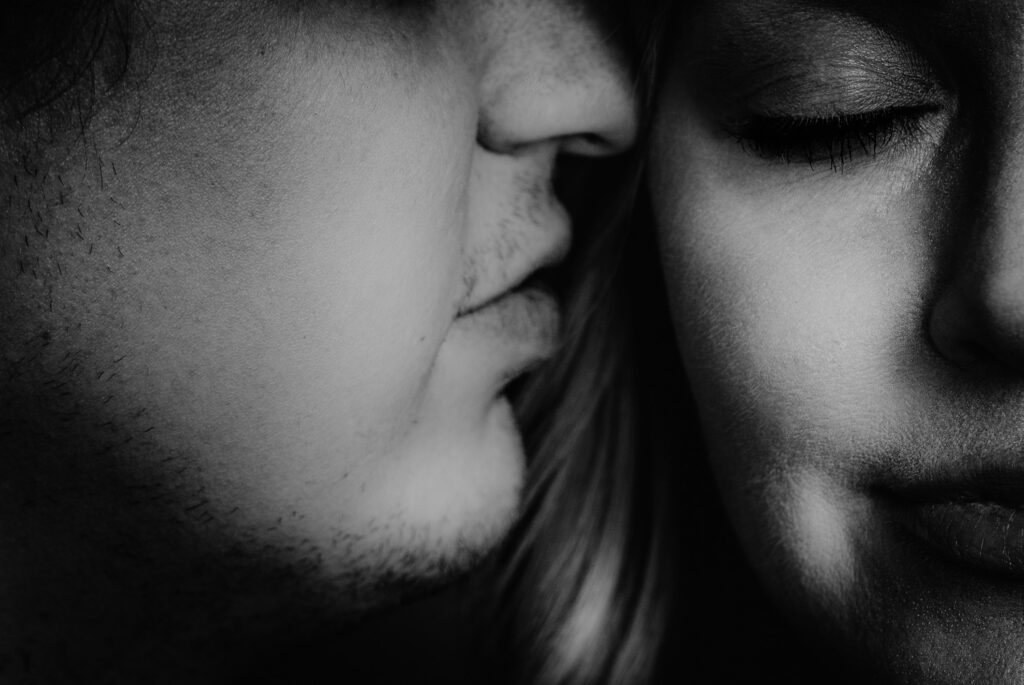 boy whispering in girls ear