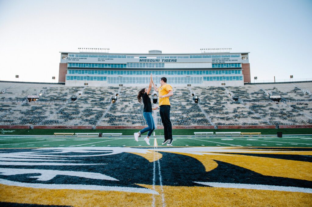 girl high fiving fiance at Mizzou stadium