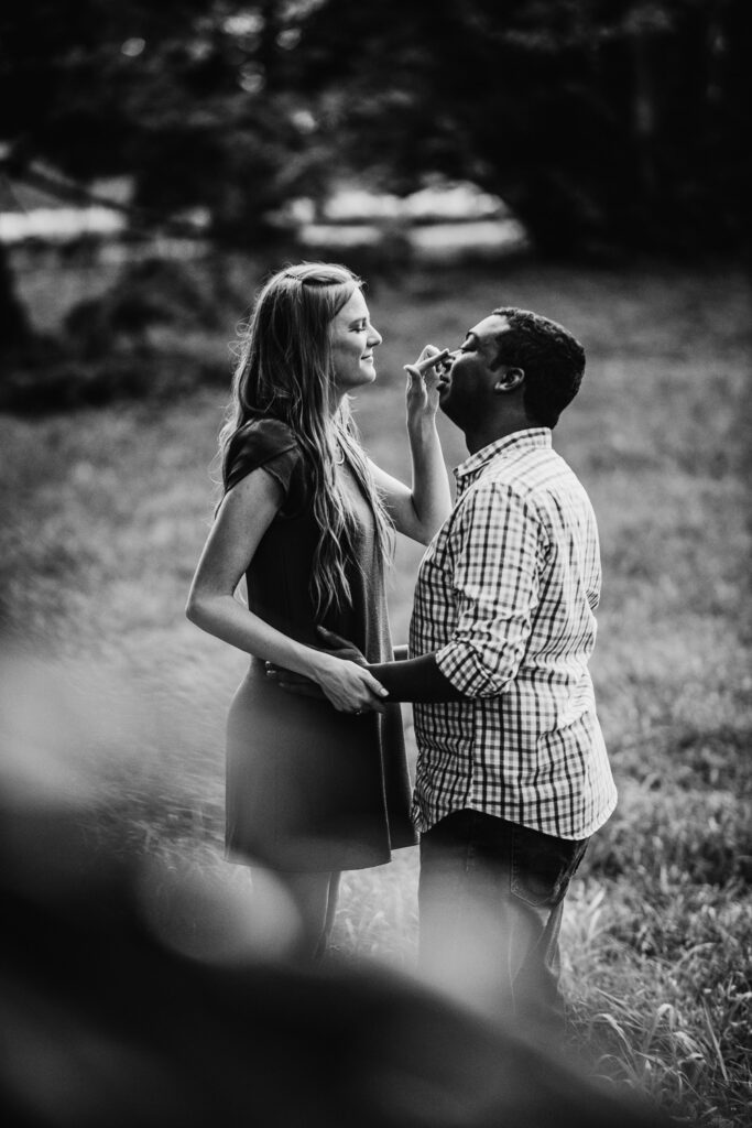 girl touching tip of nose on fiance