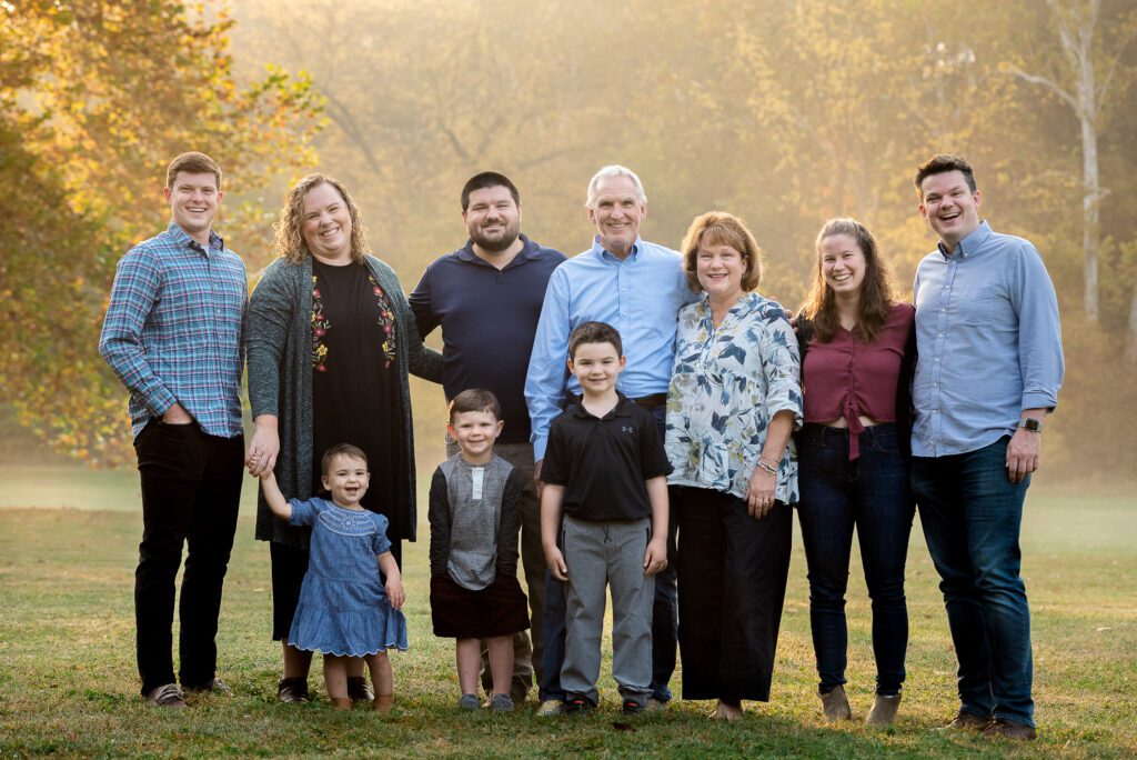 extended family in foggy field smiling
