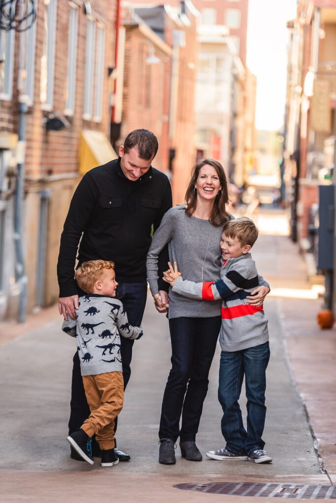 Downtown Columbia Missouri family hugging in alley