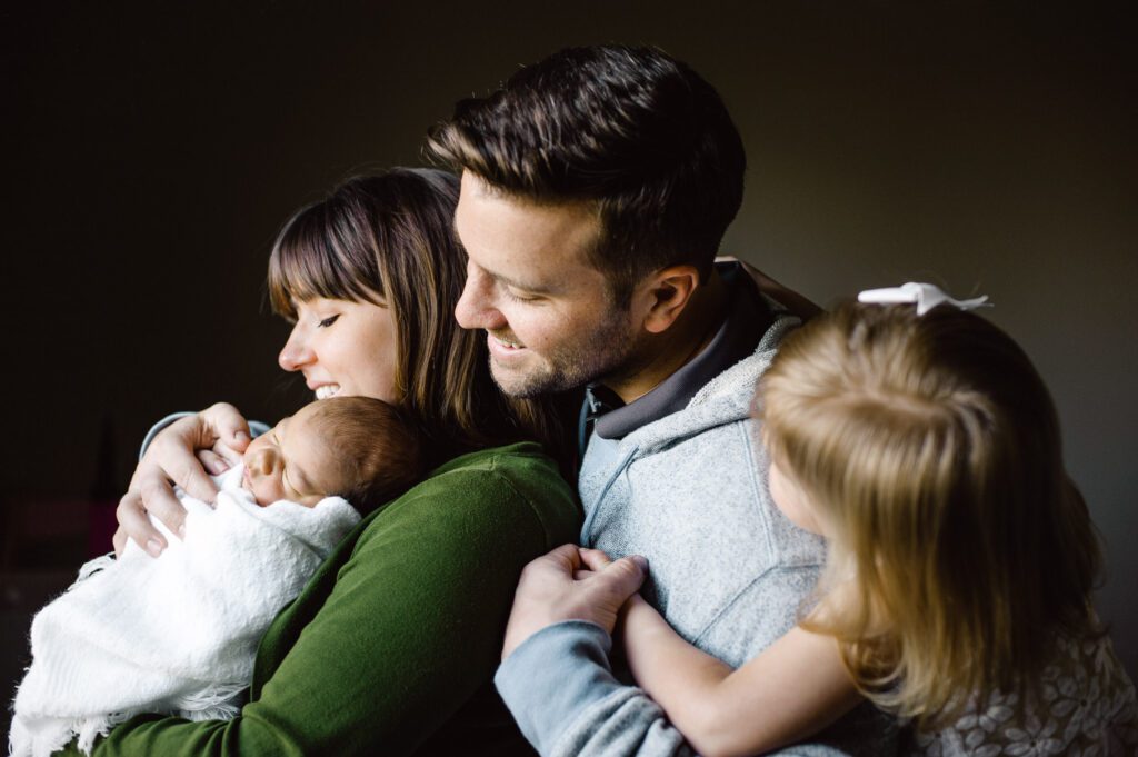 family looking at newborn baby brother in Columbia, MO