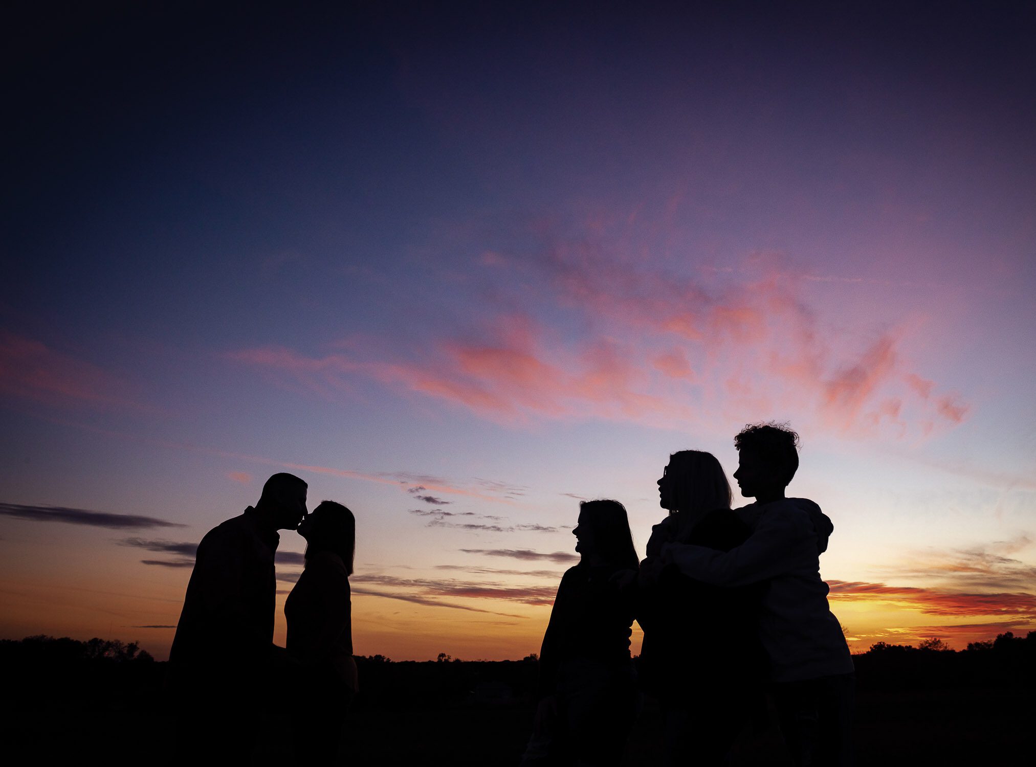 family in sunset silhouette