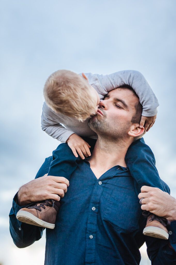 father kissing son on shoulders rock bridge state park