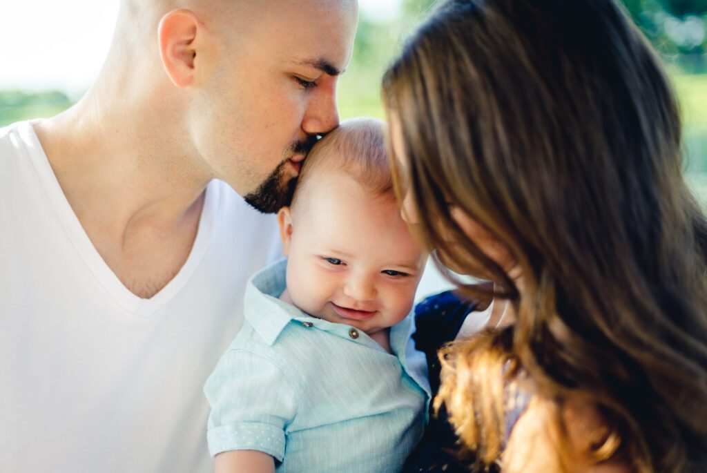 Father kissing son family photos at Stephens Lake