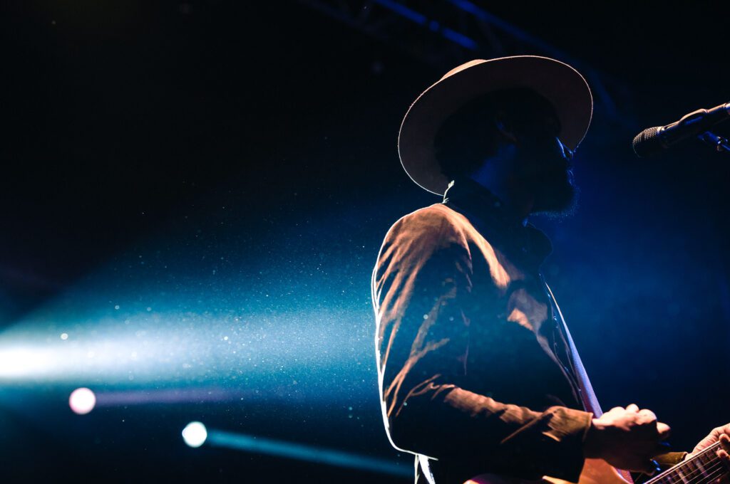 Gary Clark Jr under lights singing