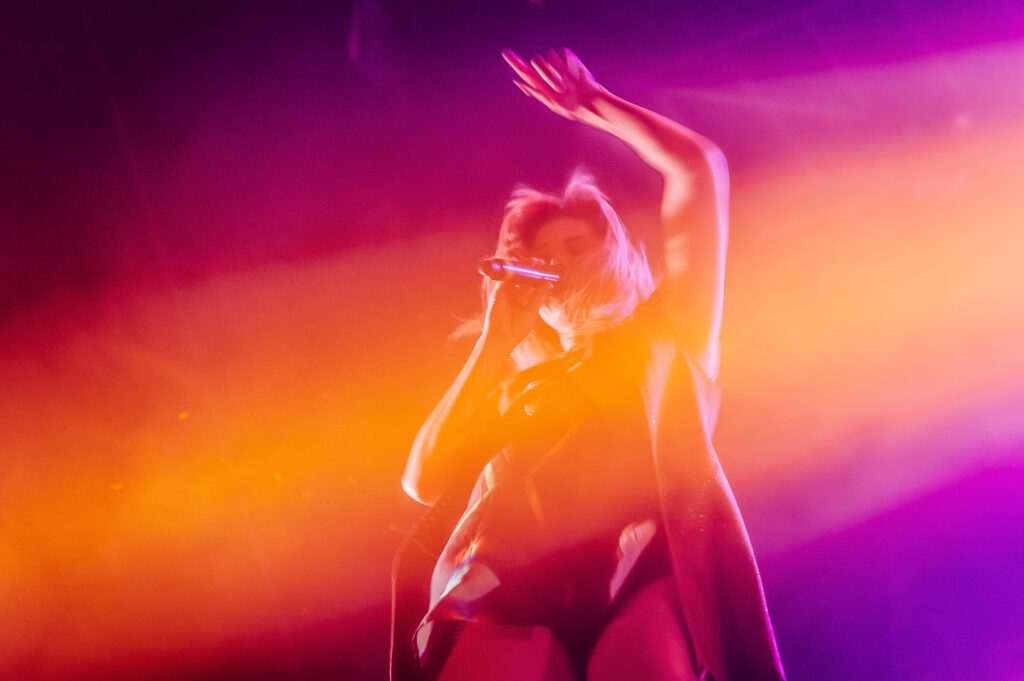 Grace Potter under orange and purple lights