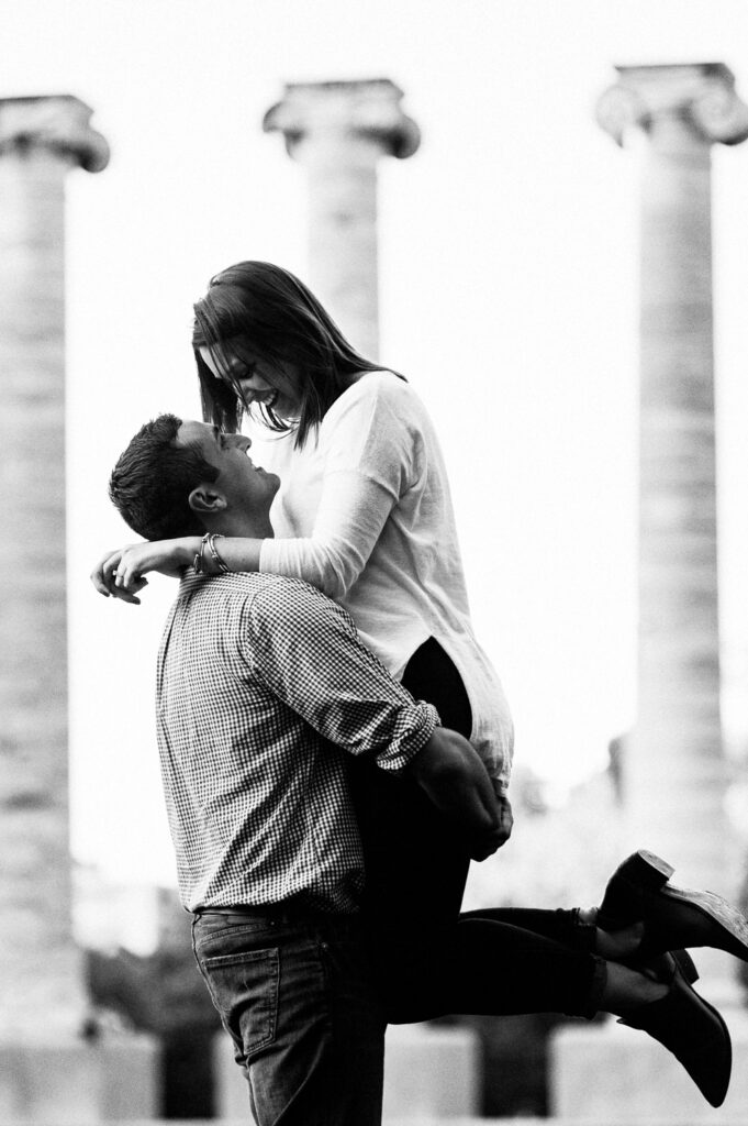 guy holding up girl in front of Mizzou columns