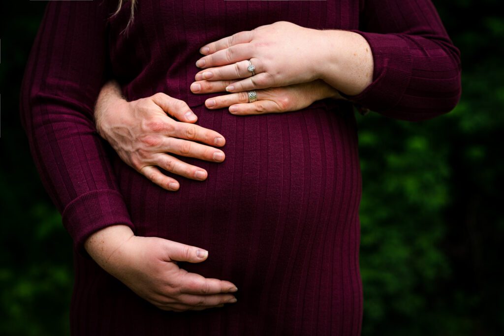 pregnant couple holding belly