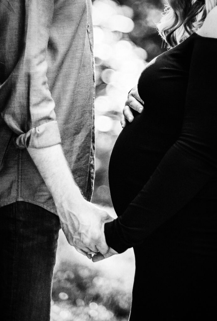 husband holding pregnant wife's hand