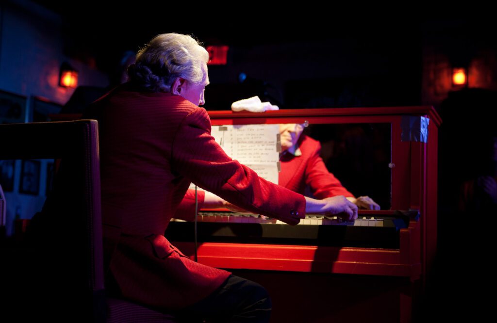 Jerry Lee Lewis at red piano at Memphis Honkey Tonk