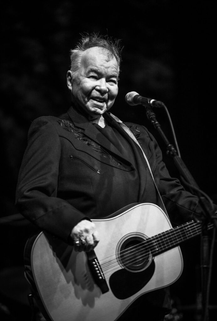 John Prine smiles at crowd