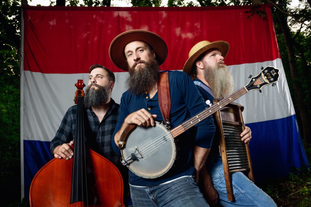 kay brothers stand with instruments in front of Missouri flag