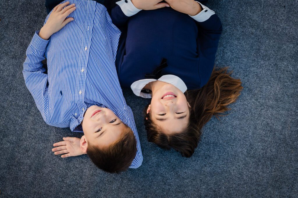 brother and sister looking up smiling
