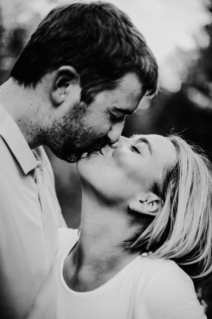 taller fiance leaning to kiss girl