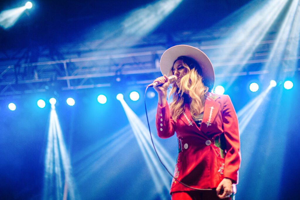 Margo Price wearing red suit designed by ashlyn evans western wear