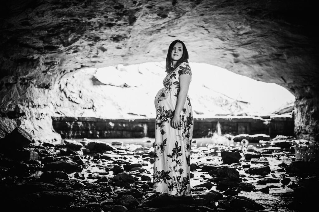 maternity pose under rock bridge