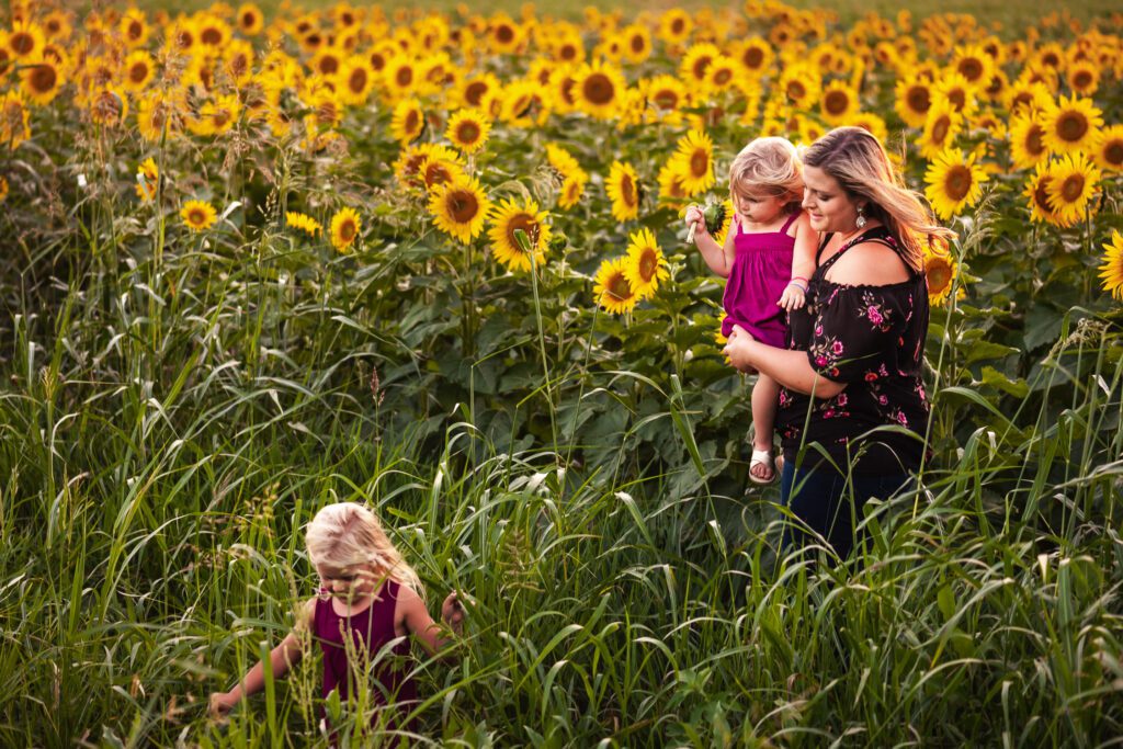 Mother and daughters in sunflower field near hartsburg missouri