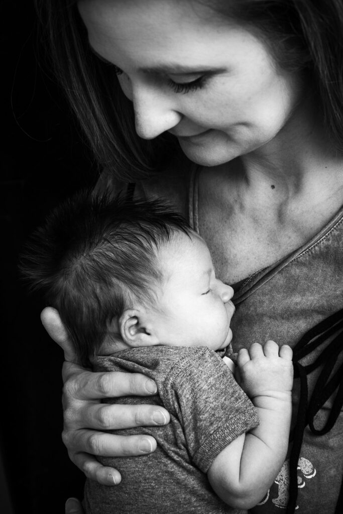 mother holding newborn on her chest in Columbia, MO