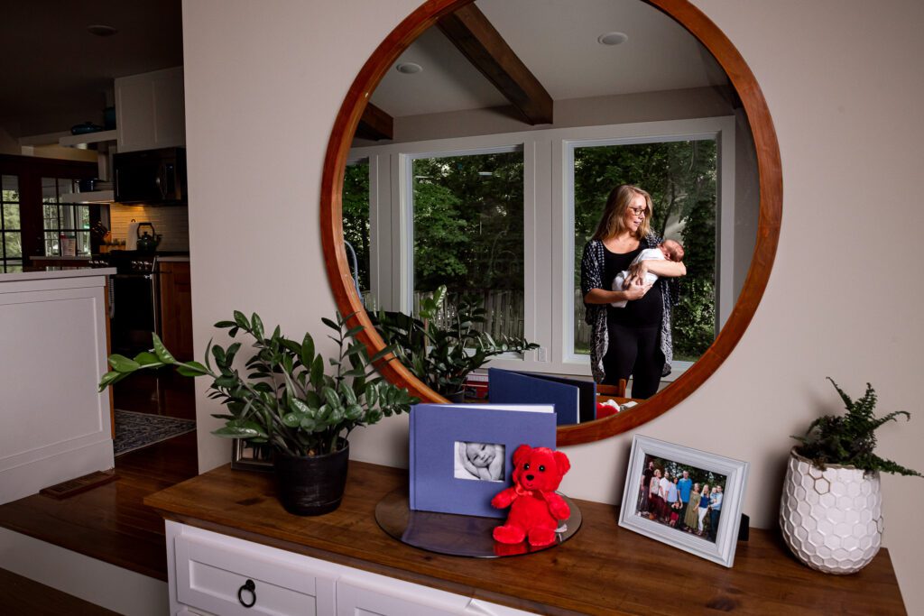 mother and newborn reflected in mirror at home in Columbia, MO