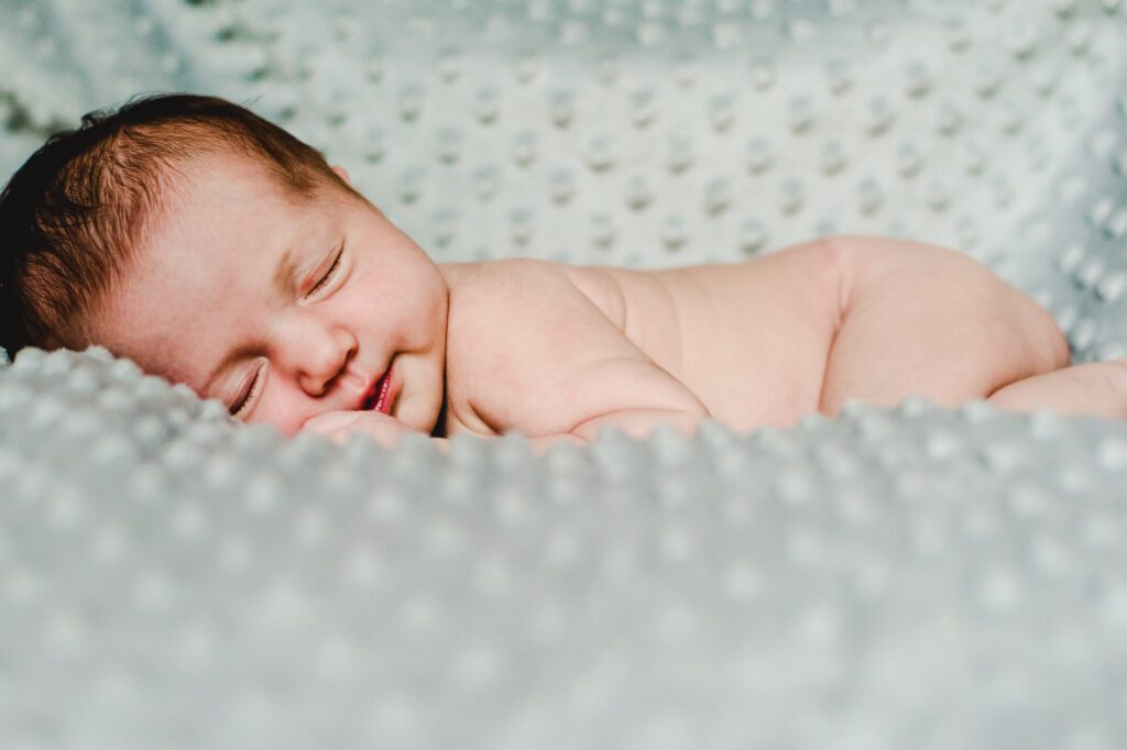 newborn naked baby posed on light blue minky blanket in Columbia, MO