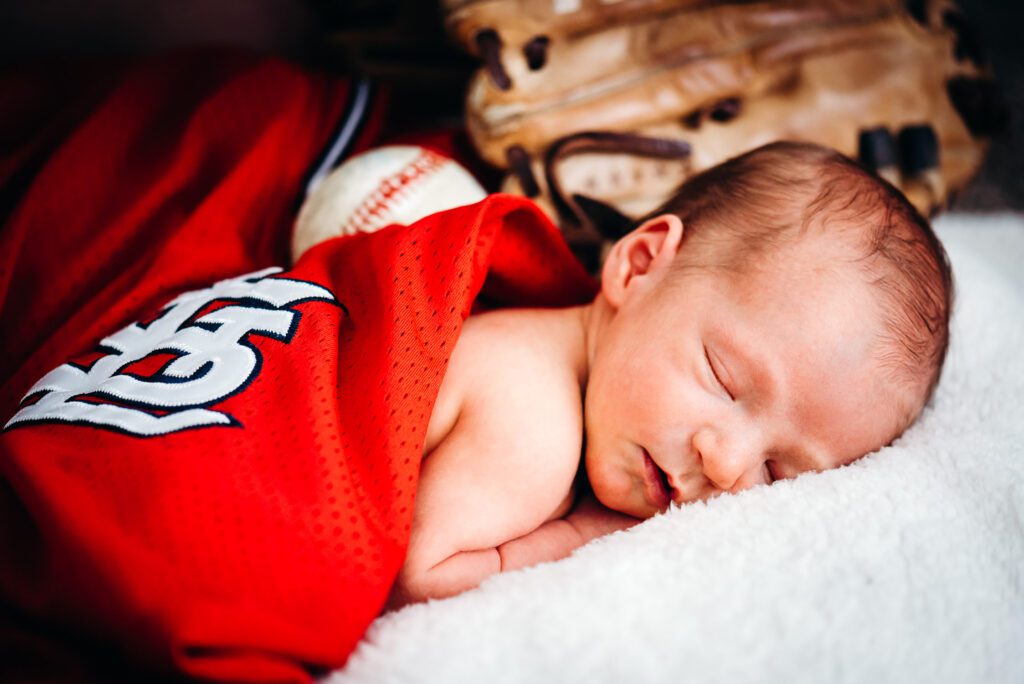 newborn wrapped in st louis cardinals jersey