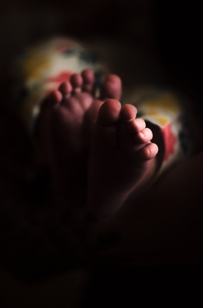 newborn toes in a dimly lit room