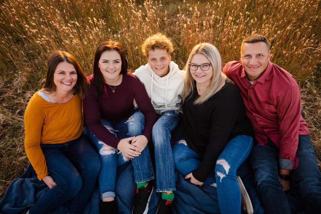 parents with older kids in sunset field