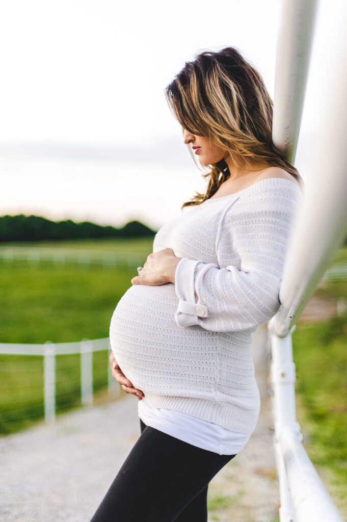 pregnant woman holding stomach at Warm Springs Ranch, MO