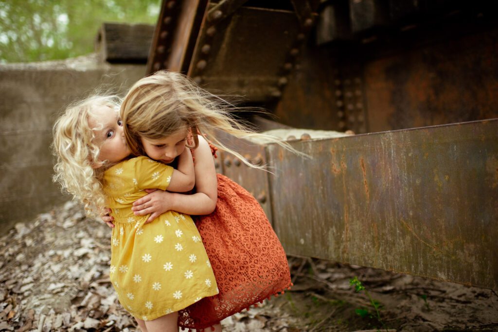 two small girls hug each other