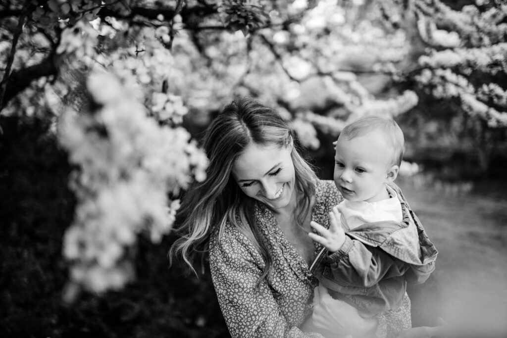 Mother smiles as she holds young son
